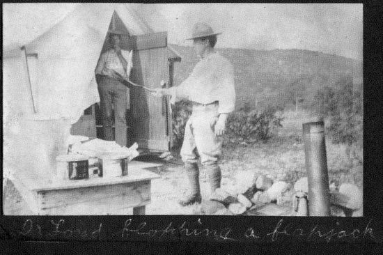 Francis Lloyd flops flapjacks with Burt Bovee looking on. Photo from the records of the Long Family.